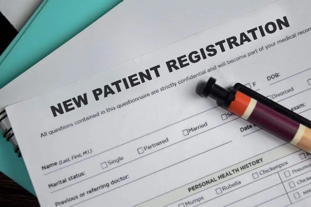 A new patient form with a pen
