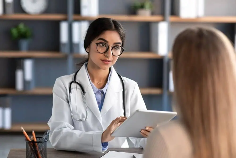 Friendly attentive doctor helping a new patient
