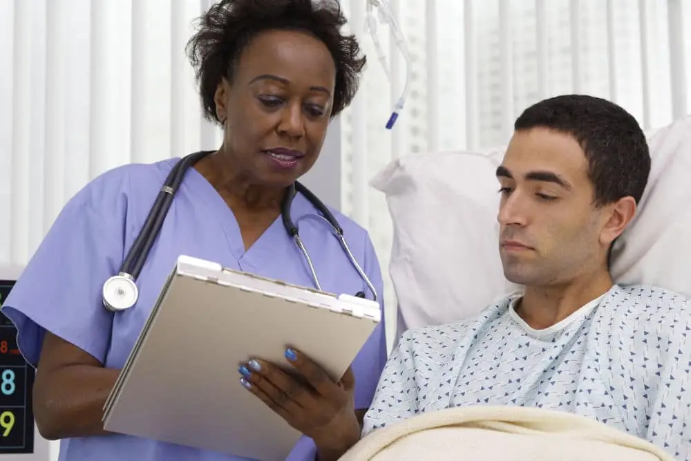 A nurse helping a patient with paperwork